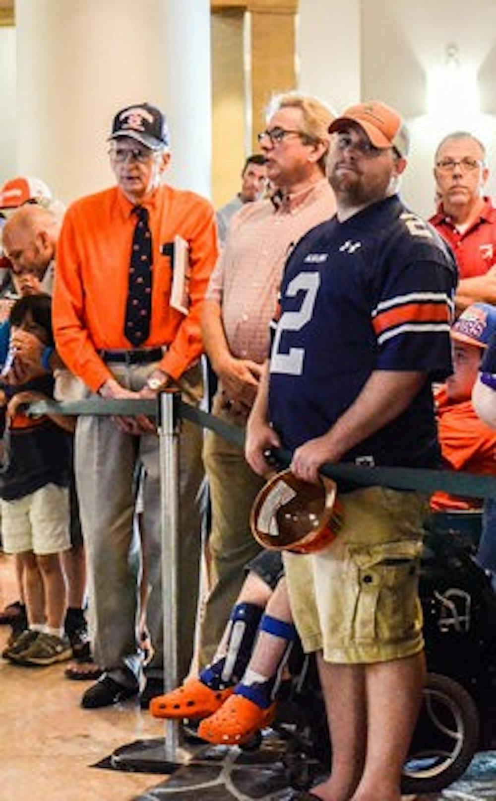 Left to right: Dickie Pearson, Jim McDaed and Adam Kelley wait with other Auburn fans in the lobby of the Wynfrey Hotel at SEC Media Days.
(Raye May | Photo & Design Editor)
