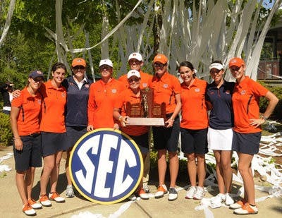 The women's golf team poses with the SEC Championship trophy after winning the title at home Sunday. The Tigers finished 11 strokes ahead of second-place Alabama. (Leffie Dailey / Auburn Media Relations)