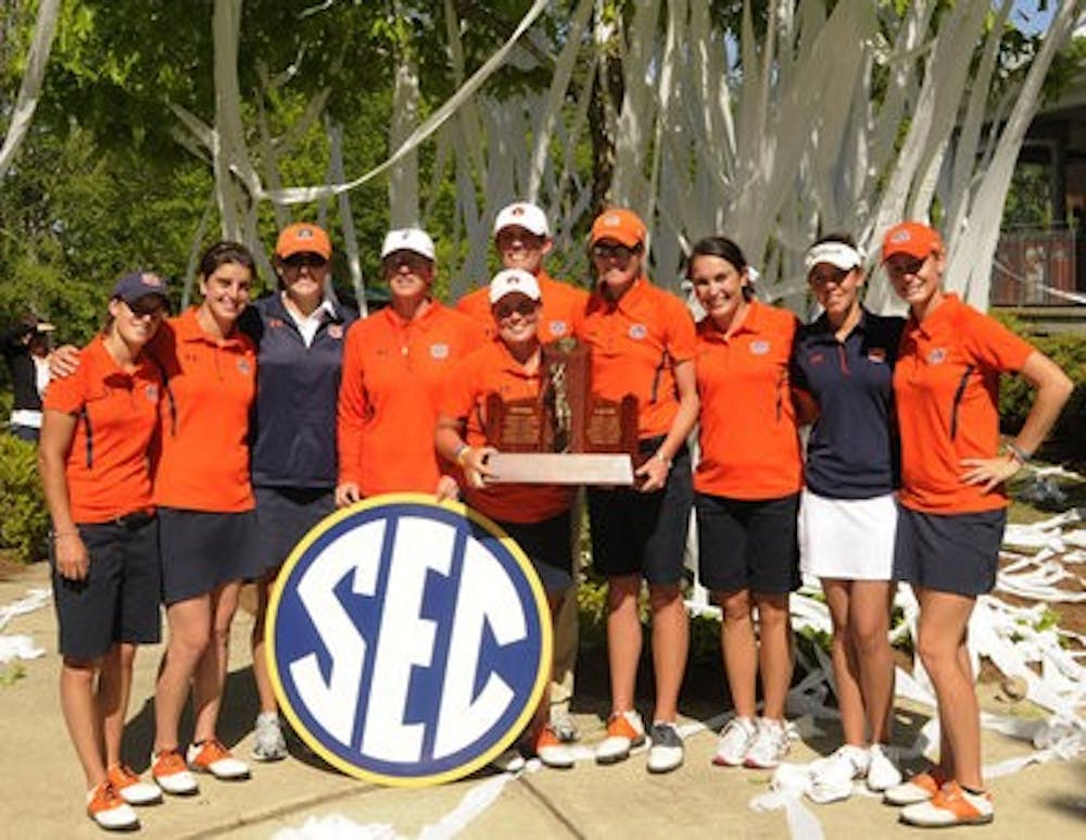 The women's golf team poses with the SEC Championship trophy after winning the title at home Sunday. The Tigers finished 11 strokes ahead of second-place Alabama. (Leffie Dailey / Auburn Media Relations)