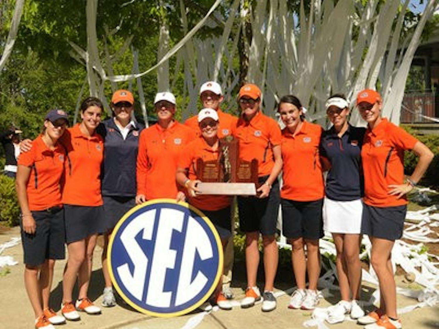 The women's golf team poses with the SEC Championship trophy after winning the title at home Sunday. The Tigers finished 11 strokes ahead of second-place Alabama. (Leffie Dailey / Auburn Media Relations)