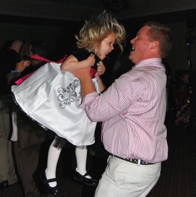 A father thrills his daughter by lifting her in the air at Daddy-Daughter Date Night Saturday. (Rebekah Weaver / Assistant Photo Editor)