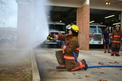 Student firefighters perform regular drills to prepare for fighting fires. (Kenny Moss | Photographer)