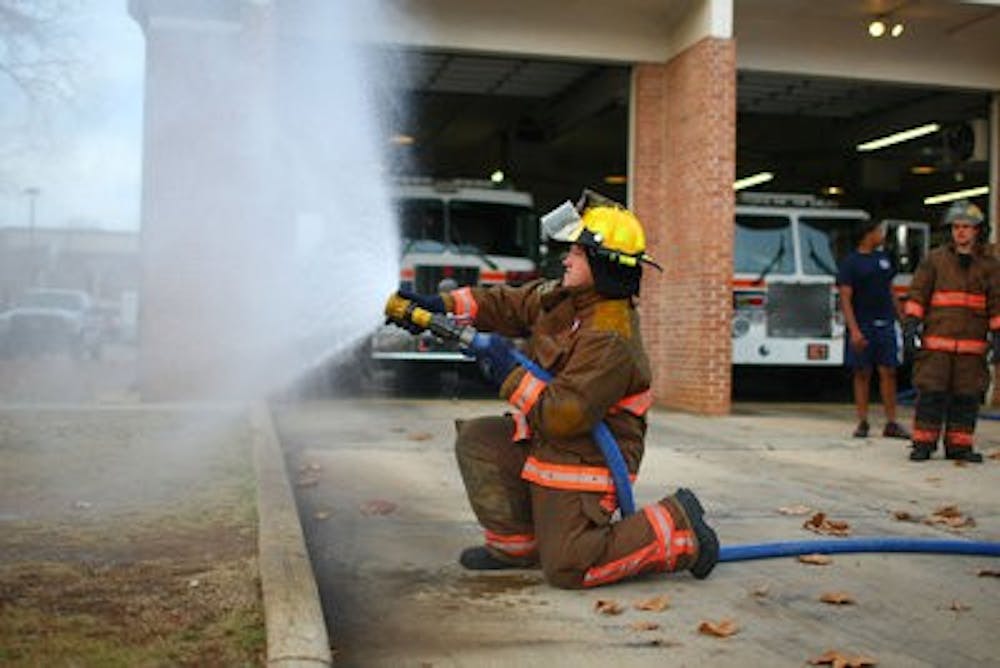 Student firefighters perform regular drills to prepare for fighting fires. (Kenny Moss | Photographer)
