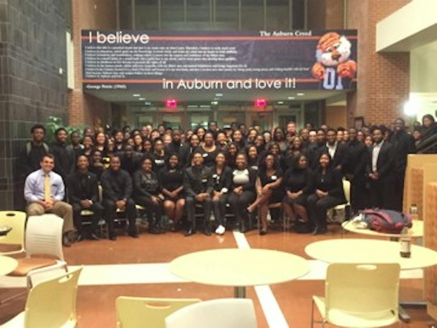 Members and attendees posed for a photo with SGA President Walker Byrd after the meeting. 