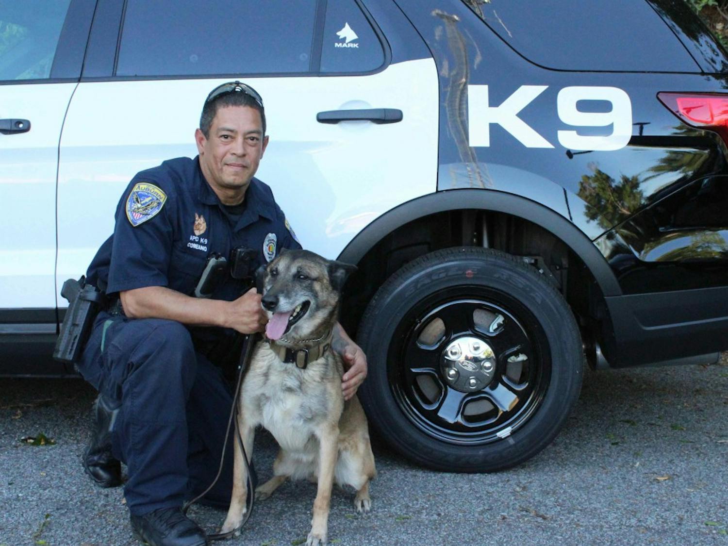Auburn Police Officer Luis Coreano and K-9 Mark in front of their new police vehicle on April 16, 2018.