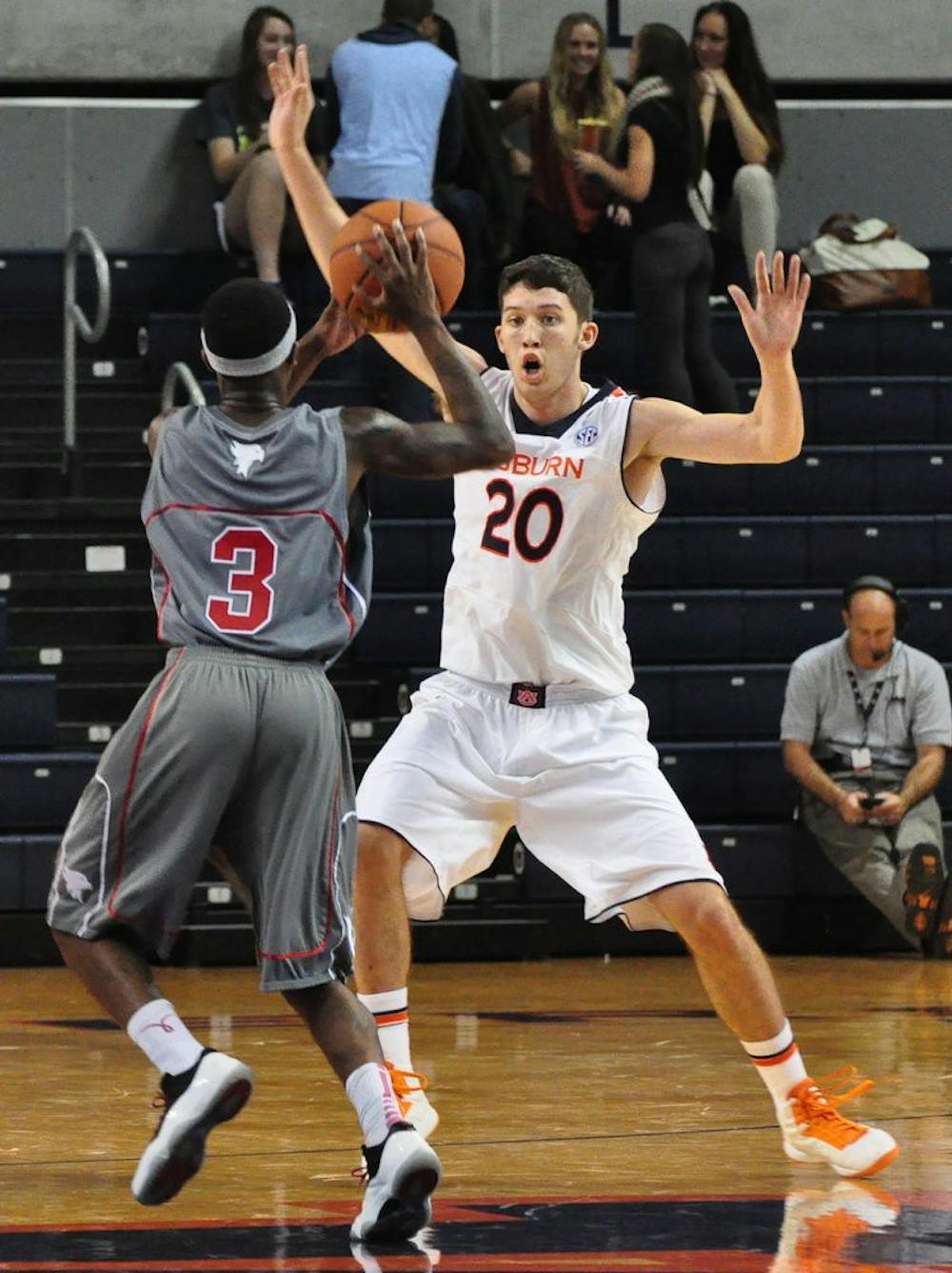 Freshman forward Alex Thompson attempts to block Victory's Michael Davis. (File photo)