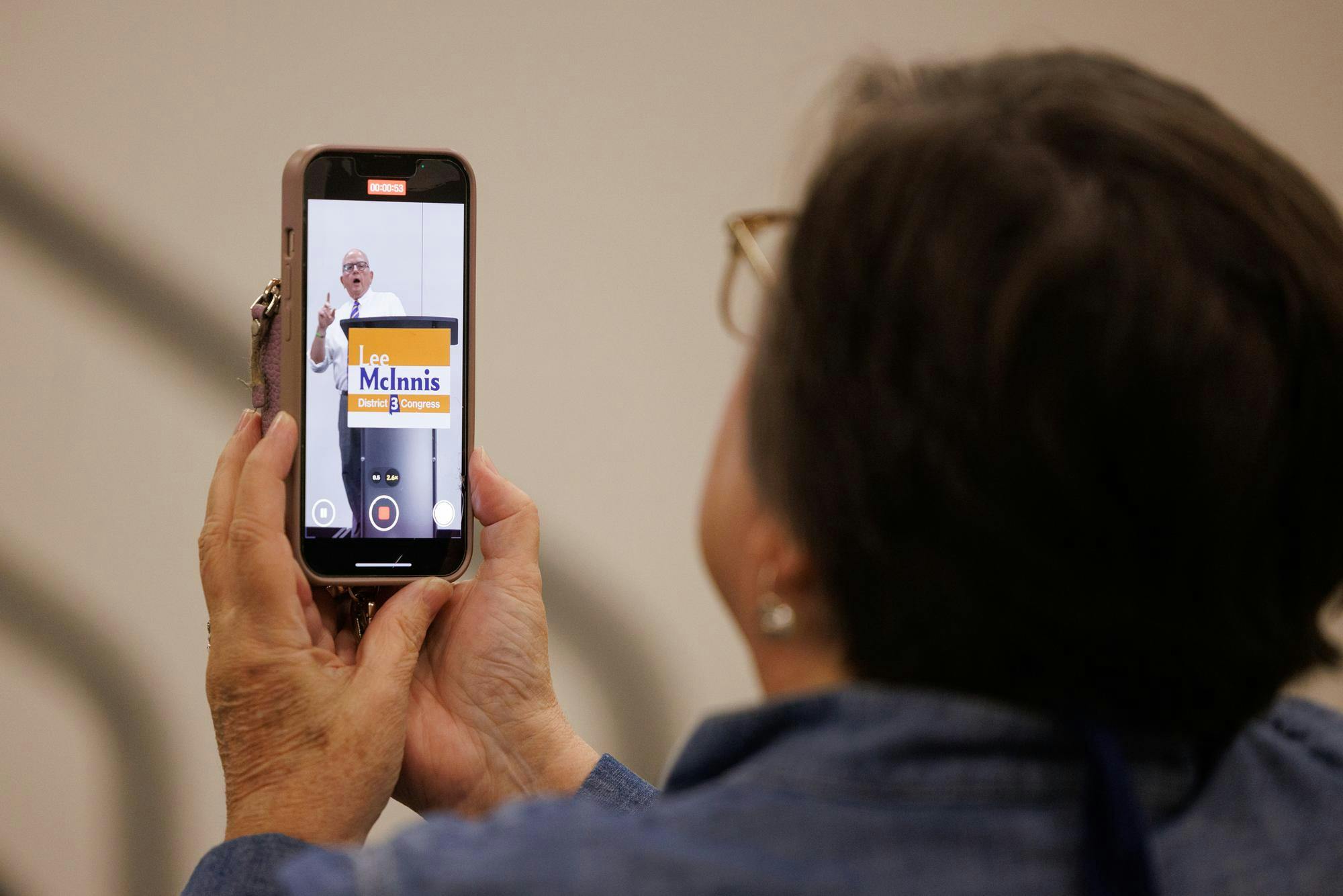 People throughout the audience film and take photos of Congressional candidate Lee McInnis on Nov. 19, 2025.