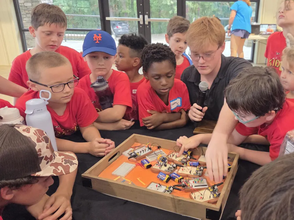 Joseph Rusk shows a group of kids The Breadboard Company's electronics starter kit. | Contributed by Joseph Rusk.