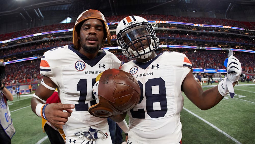 <p>The Auburn Tigers celebrate with the Old Leather Helmet after winning the Chick-fil-A Kickoff at Mercedes-Benz Stadium, Saturday, September 1, 2018, in Atlanta. (Paul Abell via Abell Images for Chick-fil-A Kickoff)</p>