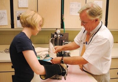 Jamie Bellah of the Southeastern Raptor Center and volunteer Maggie Mills, junior in animal science, perform the final medical exam on a broad-winged hawk before its release into the wild.

(Maria Iampietro / Photo Editor)