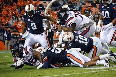 Samford's Robert Clark #85 tackled by Auburn's Johnathan Ford #23 in the first half. Samford vs Auburn at Auburn, AL on Nov 22, 2014. (Emily Enfinger | Assistant Photo Editor)\0x200B