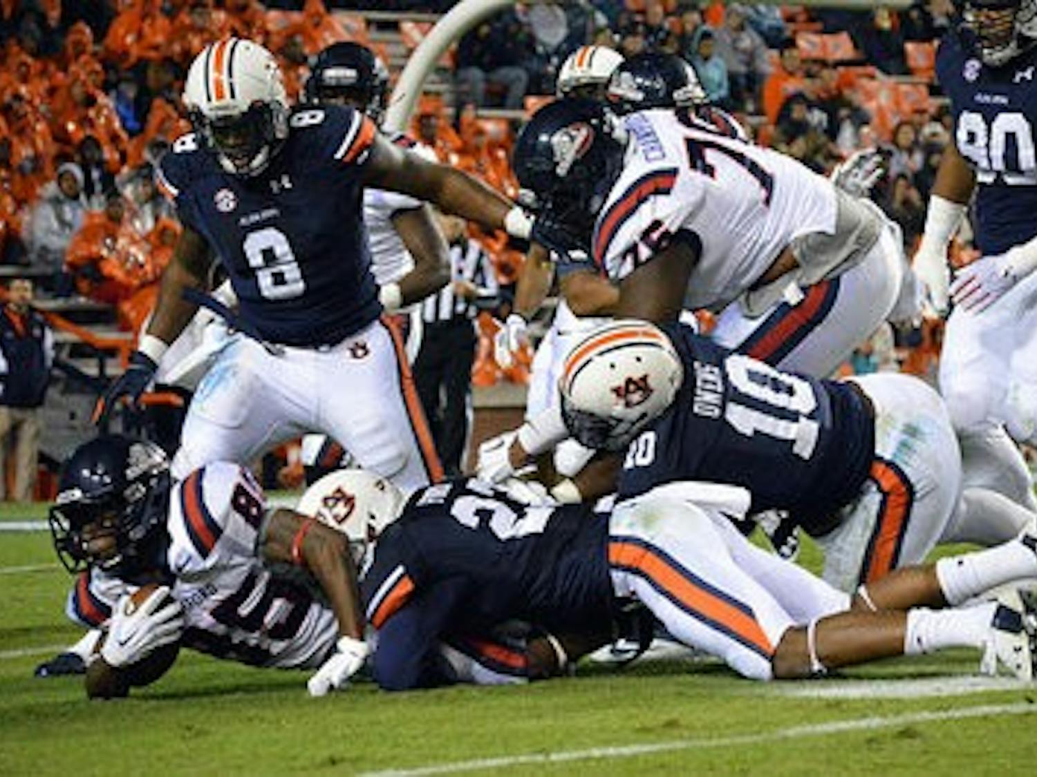 Samford's Robert Clark #85 tackled by Auburn's Johnathan Ford #23 in the first half. Samford vs Auburn at Auburn, AL on Nov 22, 2014. (Emily Enfinger | Assistant Photo Editor)\0x200B