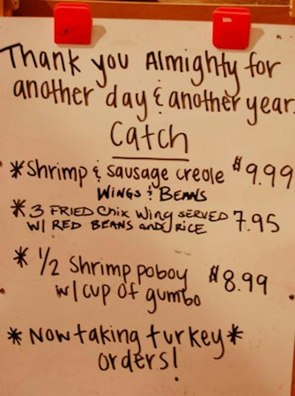 The Creole Shack menu displays the daily specials and a note to the power above for another year of business. (Charlie Timberlake / Assistant Photo Editor)