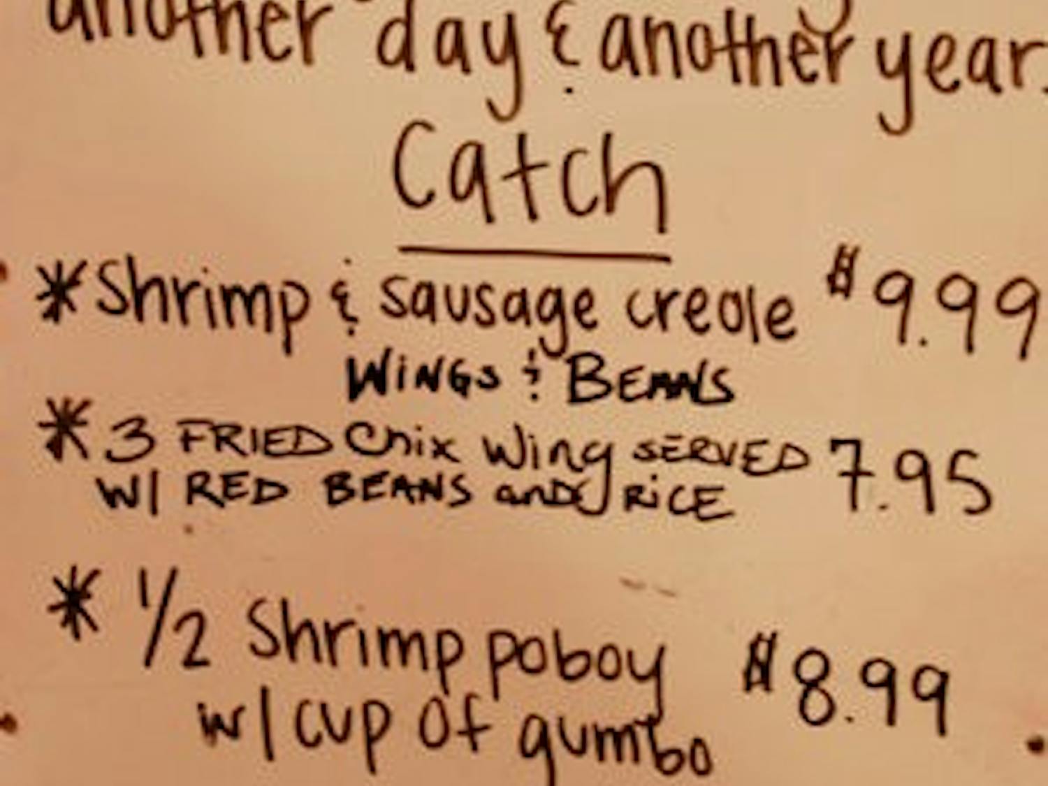 The Creole Shack menu displays the daily specials and a note to the power above for another year of business. (Charlie Timberlake / Assistant Photo Editor)