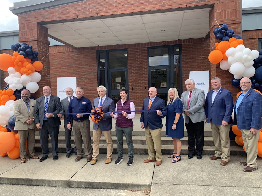 Auburn Mayor Ron Anders, Auburn University President Chris Roberts and others pose in front of AMTC.