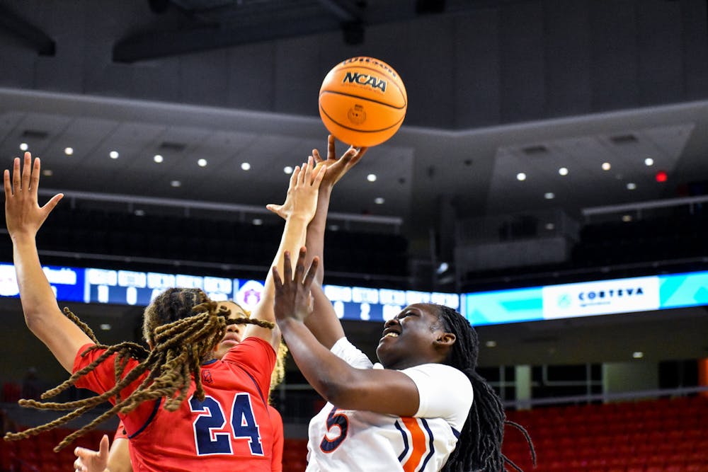 Aicha Coulibaly (5) tries to toss up a layup while surrounded by defenders in a match between Auburn and Ole Miss in the Auburn Arena on Feb. 24, 2022.