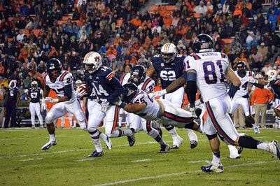 Nick Marshall #14 tackled by Samford's Jose Casanova #65 in the first half.