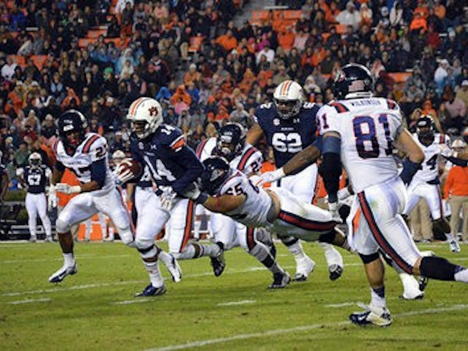 Nick Marshall #14 tackled by Samford's Jose Casanova #65 in the first half.