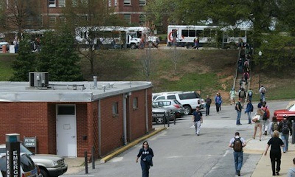 Students walk behind Petrie Hall and Jordan-Hare Stadium to get to class after being dropped off by Tiger Transits because of construction near the Haley Center drop-off points.