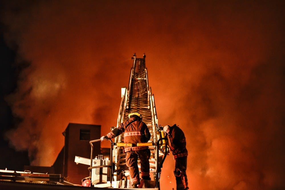 Auburn fire fighters battle a fire at Leshner Mill, Tuesday, Nov. 15, 2016 in Opelika,Ala.