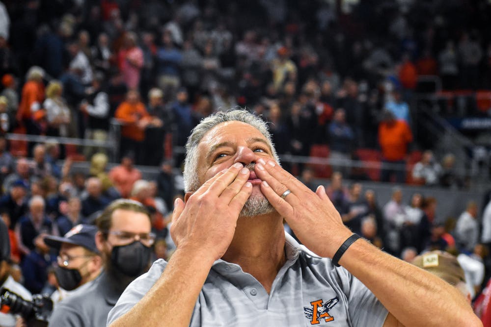 Auburn head coach Bruce Pearl kisses his hands in celebration after a match between Auburn and Oklahoma in the Auburn Arena on Jan. 29, 2022.