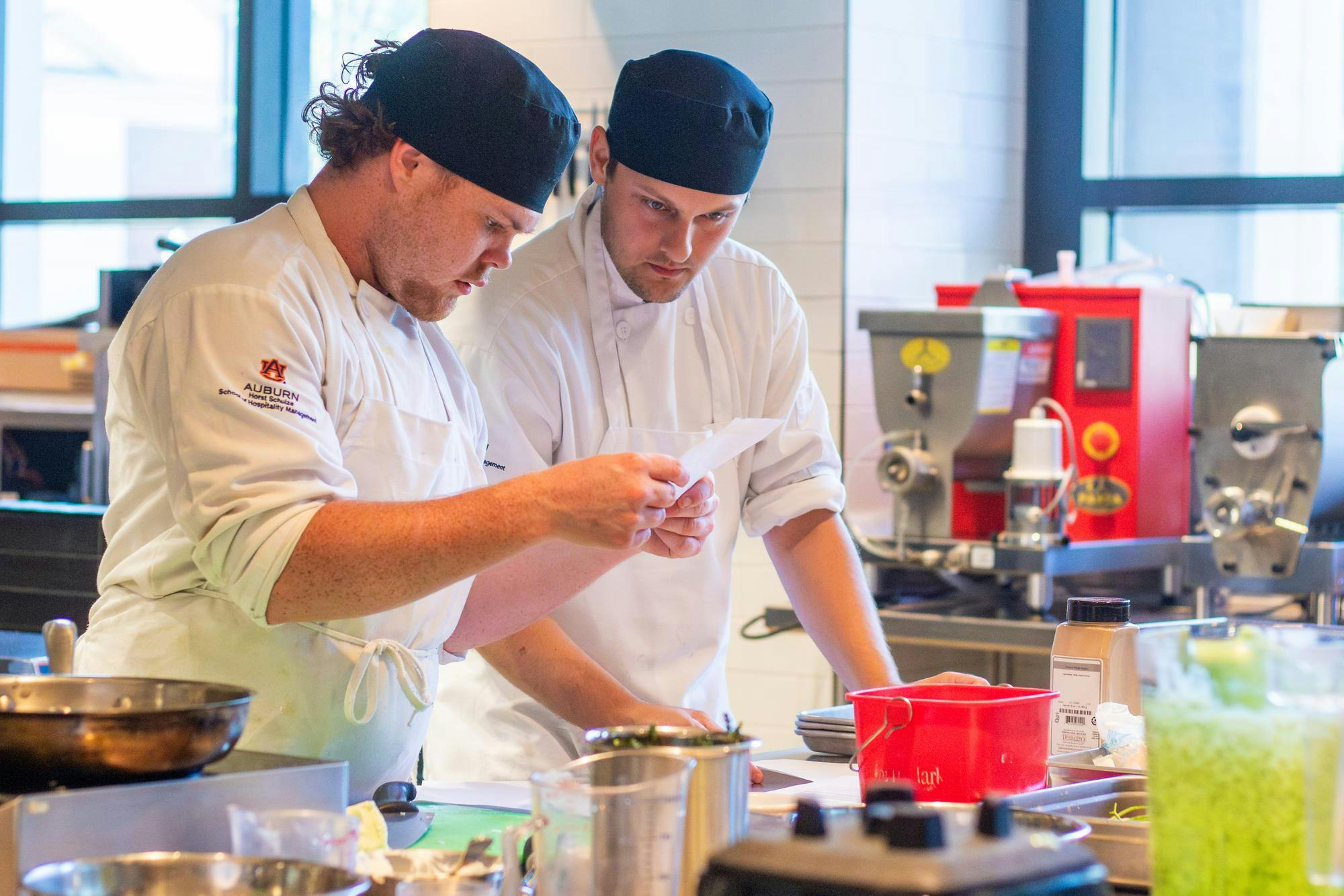 Two lab students decipher cooking instructions at the Tony & Libba Rane Culinary Science Center on Sept. 24, 2025.