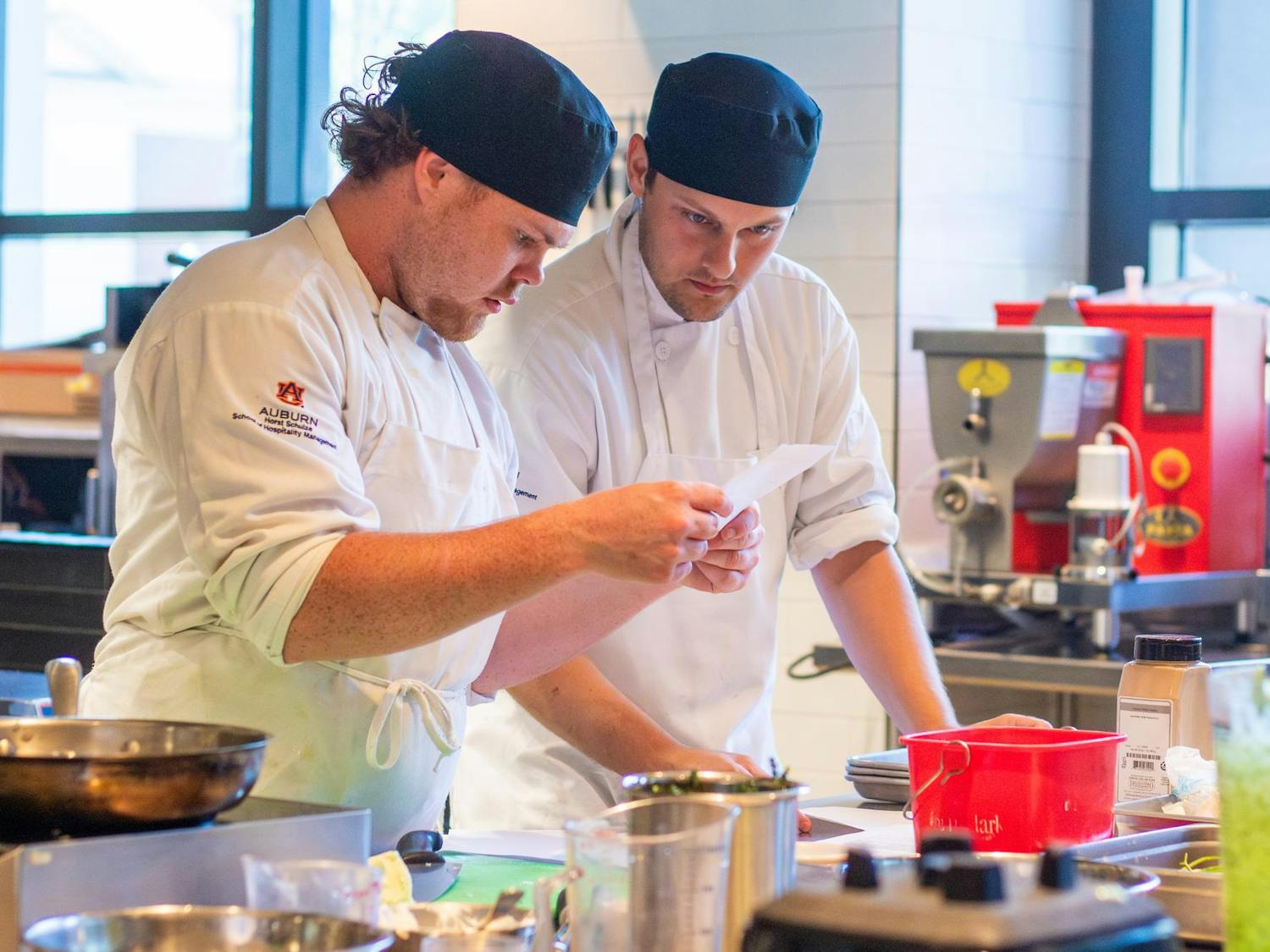 Two lab students decipher cooking instructions at the Tony & Libba Rane Culinary Science Center on Sept. 24, 2025.
