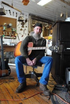 Fred Lord, owner of Fred's Feed and Seed, gives music lessons at the Pickin' Parlor in Loachapoka. (Maria Iampietro / Associate Photo Editor)