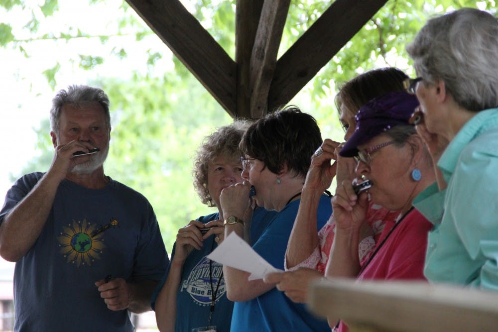 Playing tunes on harmonicas at the Old-Time Music Festival on Saturday, April 29 in Loachapoka, Ala.
