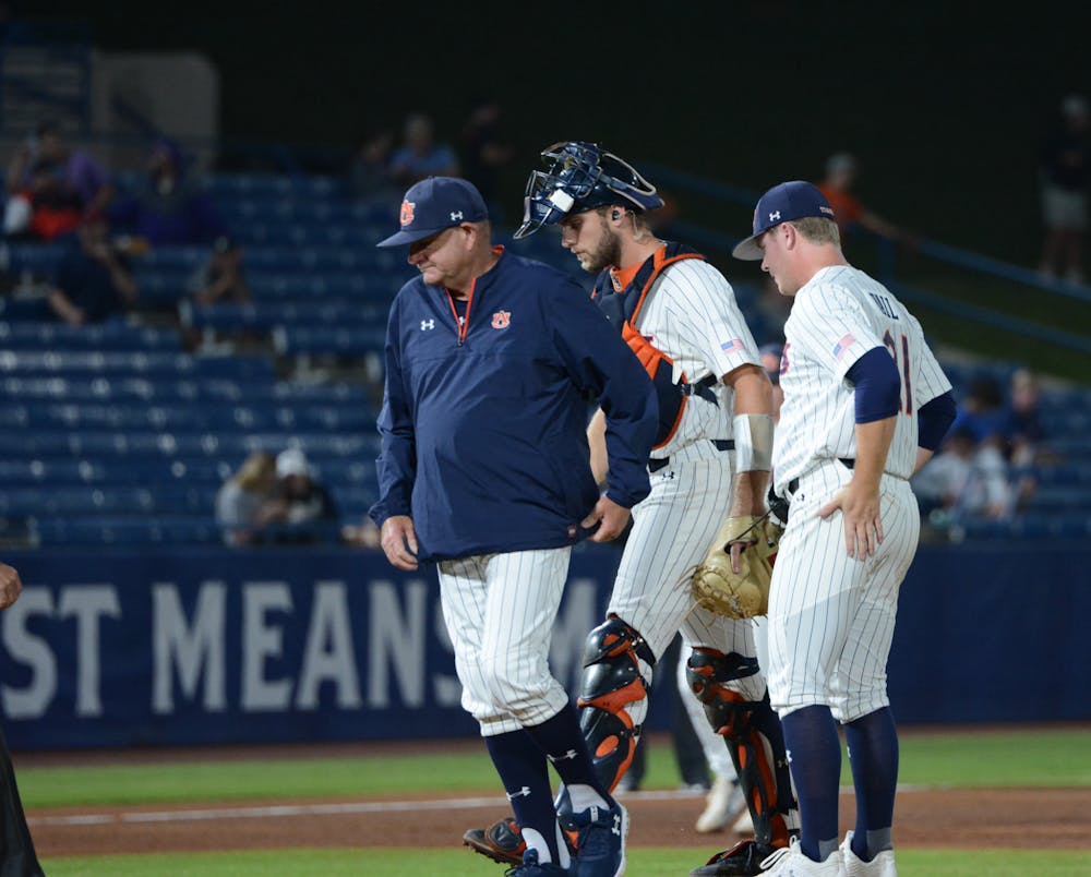 <p>Auburn pitching coach Daron Schoenrock (left), catcher Nate LaRue (middle) and pitcher Tommy Vail (right) stand at the mound at the SEC Tournament on May 23, 2022.</p>