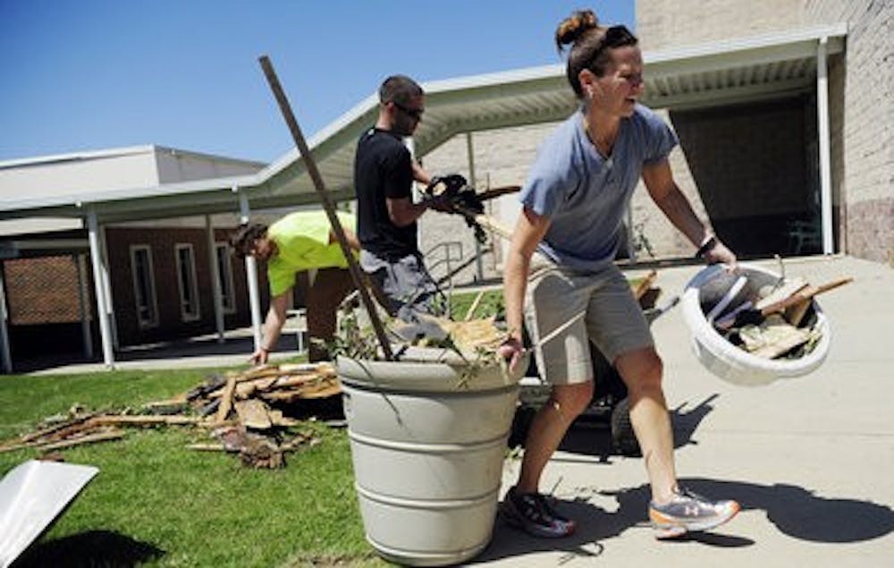 Kerry Cremeans, Dustin Landry and Joey Caldwell work to clean the tornado aftermath at First Baptist

Church in Pleasant Grove April 29,

2011. (Todd Van Emst / AUBURN MEDIA RELATIONS)