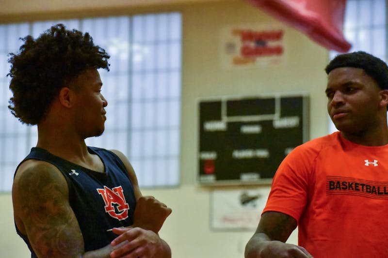 Wendell Green Jr. (1) and K.D. Johnson (0) interact during practice at a nearby Tampa school the day before Auburn's first game of the SEC Tournament on March, 10, 2022.