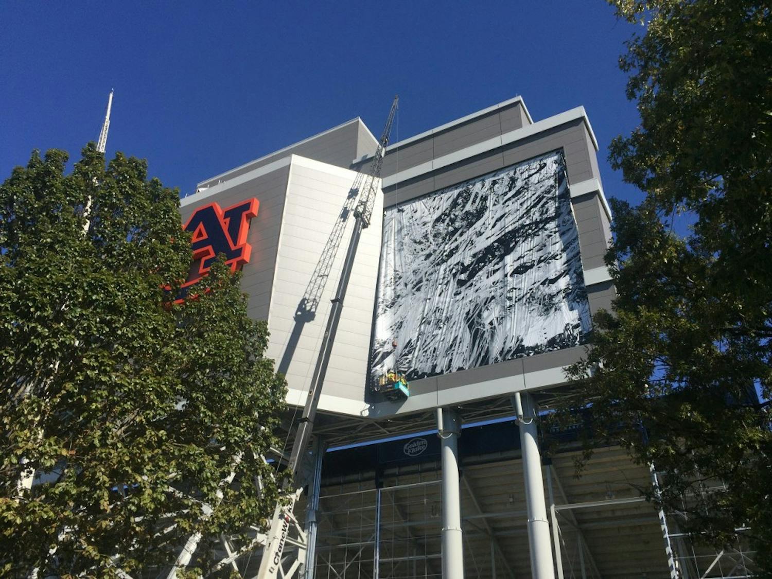Banners are placed on Auburn's scoreboard at Jordan-Hare Stadium on Wednesday, Oct. 14. (Evan McCullers | Assistant Sports Editor)