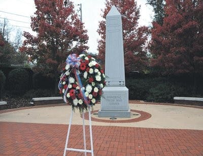 A wreath stands in front of the city of Auburn's memorial site to honor those who have served. (Katherine McCahey / PHOTOGRAPHER)