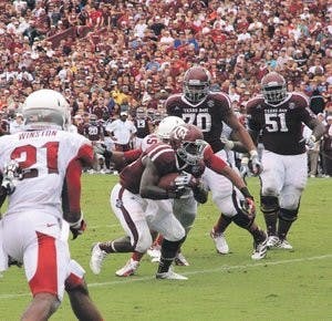 Christine Michael protects the ball from defenders. Michael has 49 rushing attempts so far this season with five rushing touchdowns. (Courtesy of The Battalion)