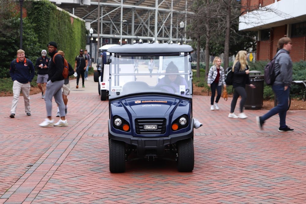 Auburn University jAUnt golf cart waits to pick up student at the Haley Center on Feb. 26, 2020, in Auburn, Ala.