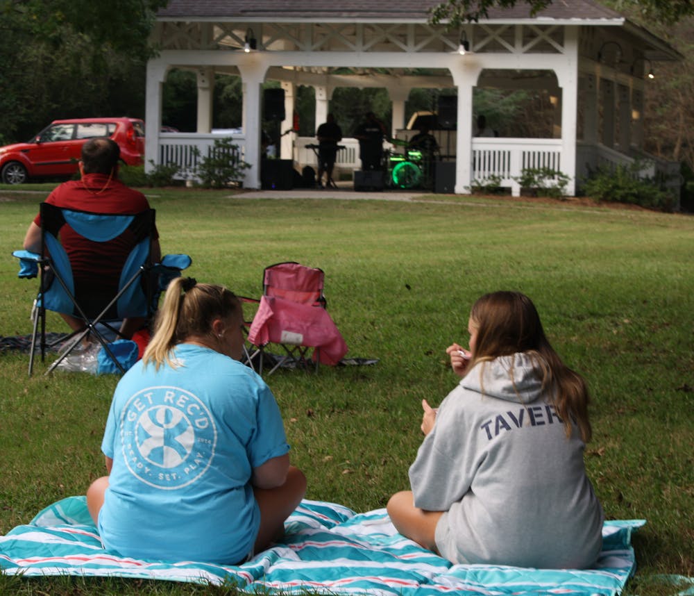 <p>Students and locals alike gather at Kiesel Park to watch performances by a number of musical groups.</p>