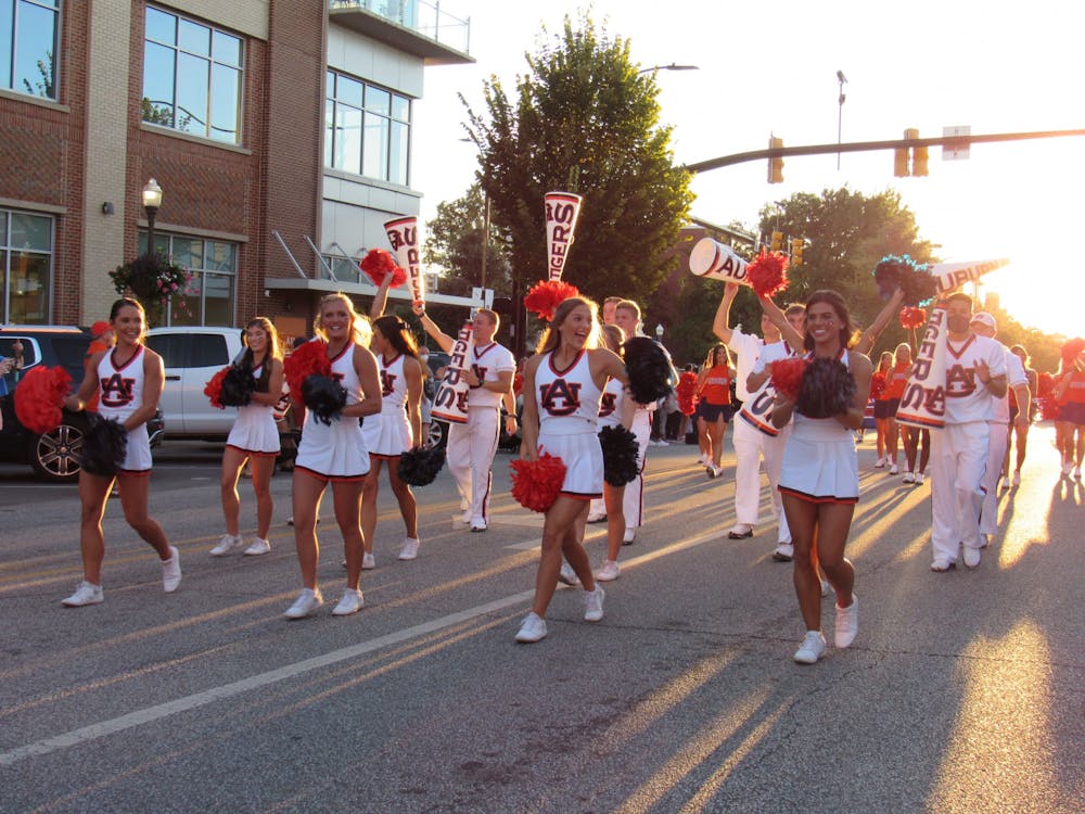 <p>The Auburn University Cheerleaders walk through the Homecoming Parade on September 24, 2021 in Auburn, Ala.</p>