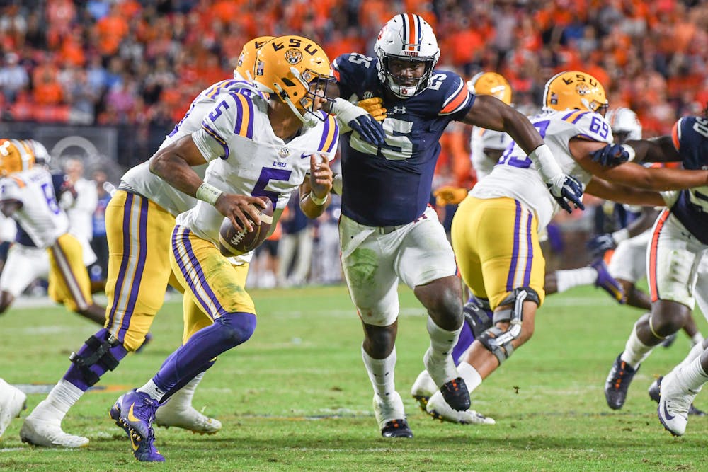 Auburn defensive end Colby Wooden (25) rushes LSU's quarterback in a matchup against LSU in Jordan-Hare Stadium on Oct.1, 2022.