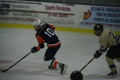 Junior right wing Pete Leone carries the puck down the ice while Jeremy Spafard pursues. (contributed)