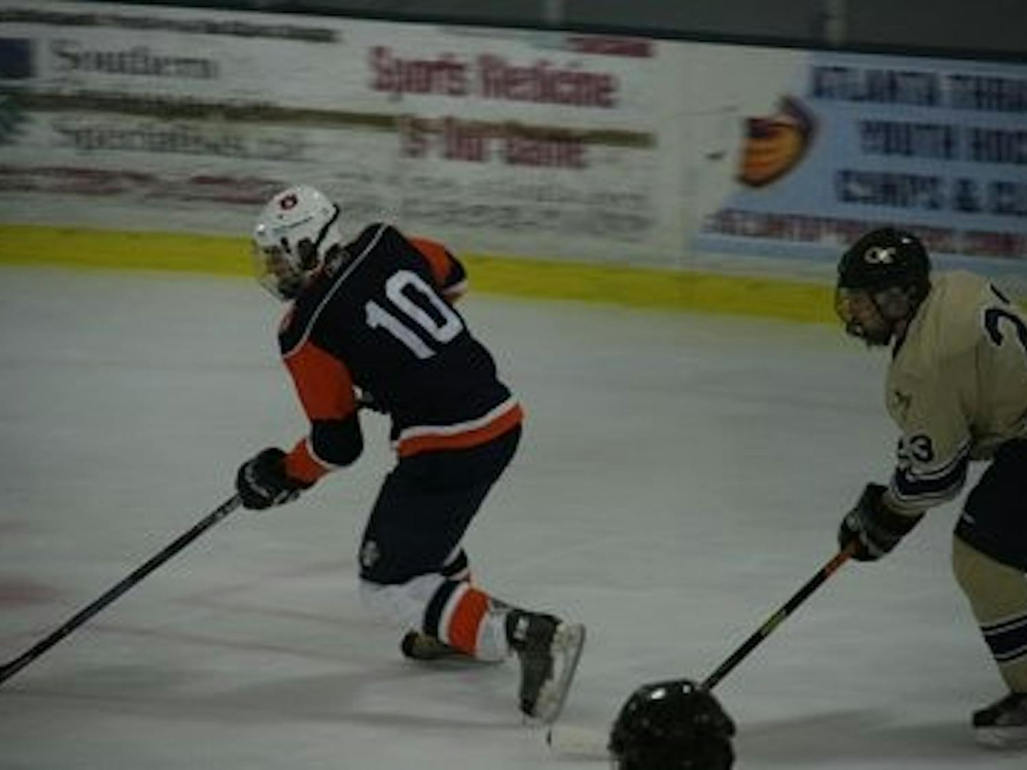Junior right wing Pete Leone carries the puck down the ice while Jeremy Spafard pursues. (contributed)