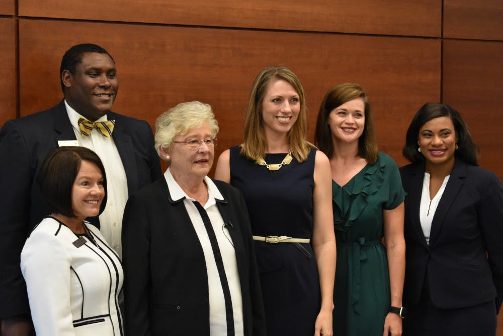 Gov. Kay Ivey with members of Auburn High School's administration on July 25, 2017 in Auburn, Ala.