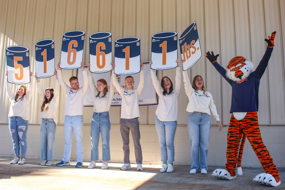 Beat Bama Food Drive Volunteers revealing food drive results with Aubie during the revealing event at Food Bank of East Alabama on Nov. 18, 2022.
