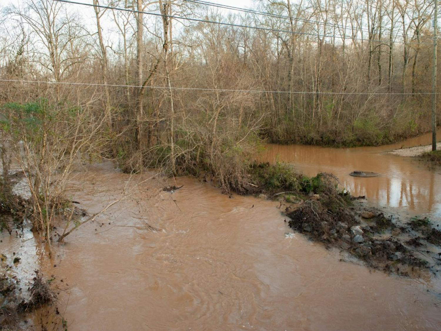 Sougahatchee Creek spread beyond its banks flooding the woods around it. Friday, Dec. 25, 2015, in Auburn, Alabama.