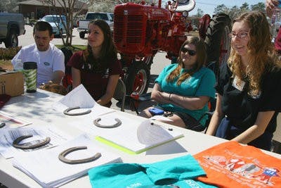 Club president Hayley Dickinson, secretary Amanda Branham and publicity chair Lauris  Orem help promote the Saddle Up for St. Jude Trail Ride happening March 5. (Rebekah Weaver / ASSISTANT PHOTO EDITOR)