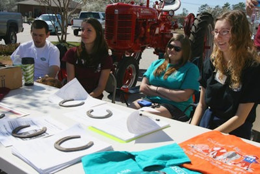 Club president Hayley Dickinson, secretary Amanda Branham and publicity chair Lauris  Orem help promote the Saddle Up for St. Jude Trail Ride happening March 5. (Rebekah Weaver / ASSISTANT PHOTO EDITOR)