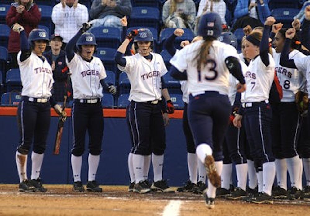 Auburn players wait for Kasey Cooper to touch home plate after hitting a grand slam against Winthrop. (Contributed by Zach Bland)