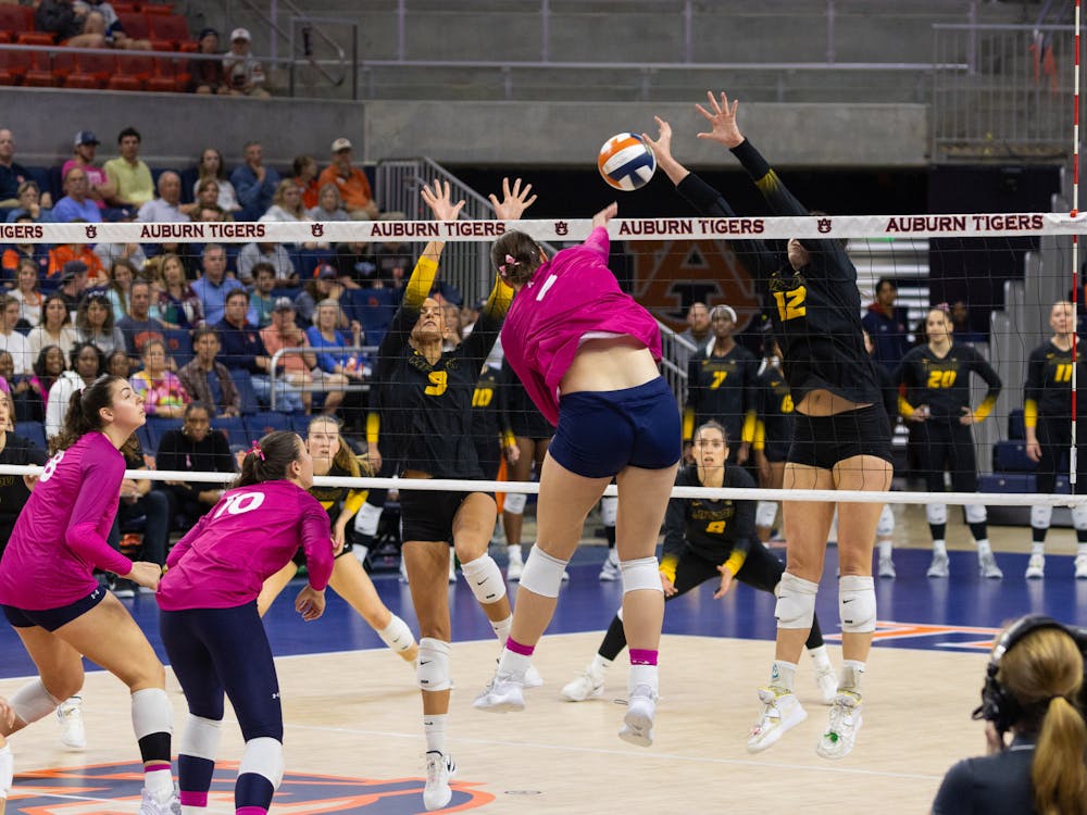 Bella Bell spikes in between two Missouri blockers during the 2nd set of Missouri at Auburn