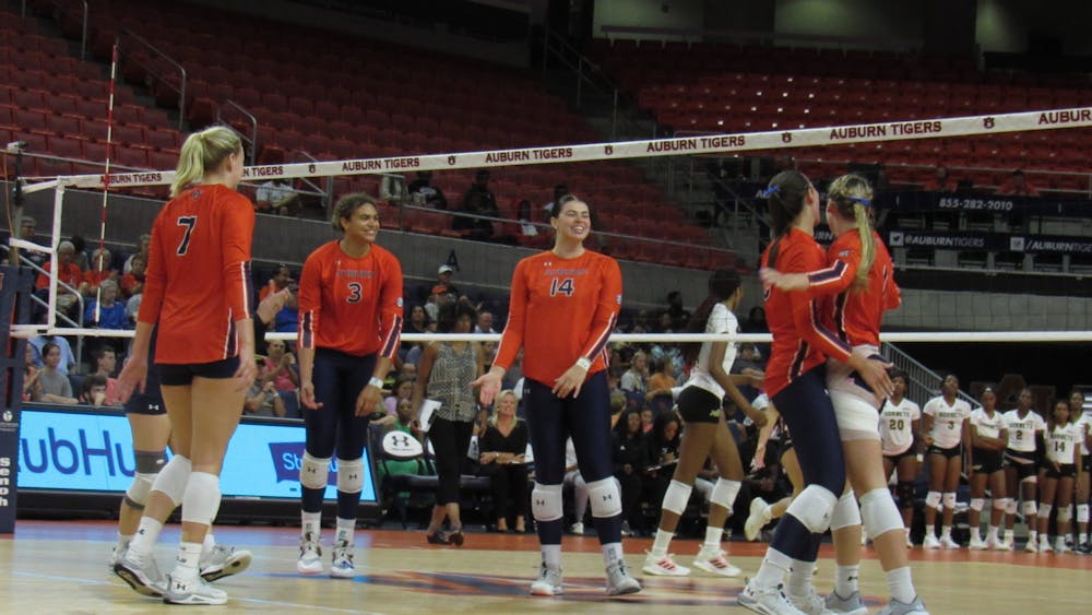 <p>The Auburn Volleyball Team celebrates after scoring against Alabama State inside Neville Arena in Auburn, Ala. on August 31, 2022.</p>
