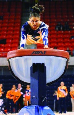 Sophomore Petrina Yokay mounts onto the vault. She received a score of 9.675 for the event. (Rebekah Weaver / Assistant Photo Editor)